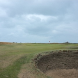 The view from the right-hand side of the 7th fairway showing the green and the hole's lone bunker.