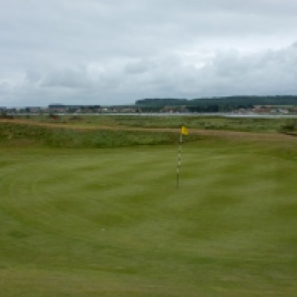 The view of the 12th green from the right-hand side showing the slightly sunken putting surface, which is blind from the fairway.