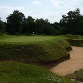 The view of the 5th green from front right. Note the huge bunker wrapping across the front and down the right-hand side of the putting surface. It is one of five bunkers that guard this green.